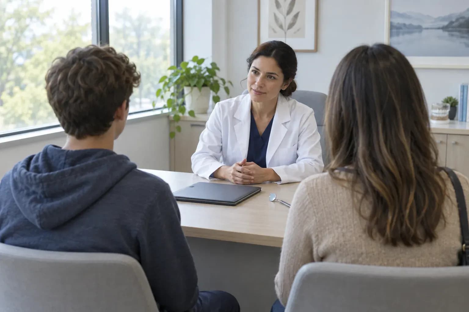 A teenager and a parent at a consultation in a bright orthodontic surgery